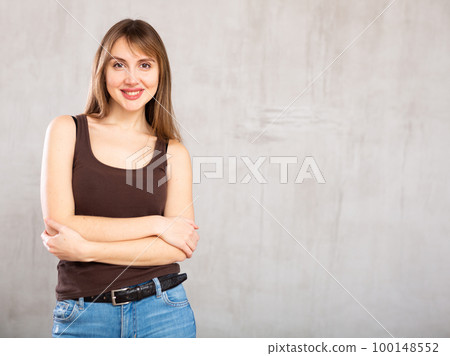 Young cheerful woman with wide grin on her face exuding happiness and positivity Young cheerful woman with wide grin on her face exuding happiness and positivity 100148552