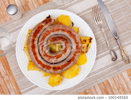 Grilled sausage garnished with potato prepared for dinner Grilled sausage garnished with potato prepared for dinner 100148560