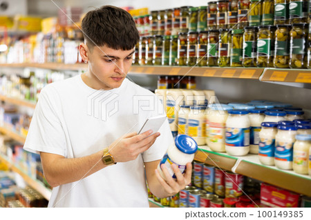 in supermarket man scans qr code from mayonnaise label 100149385