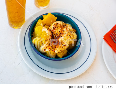 Fried Patatas bravas served with spicy sauces Fried Patatas bravas served with spicy sauces 100149530