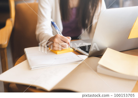 No face closeup hand young adult women writing note for study and work No face closeup hand young adult women writing note for study and work 100153705