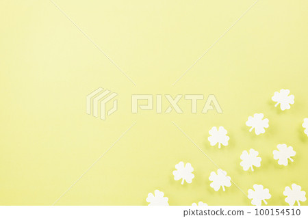 Happy St. Patrick's Day decoration background. Flat lay of cutting paper clover leaves festive decor, shamrocks leaves holiday symbol with copy space on colour background, Banner greeting card concept Happy St. Patrick's Day decoration background. Flat lay of cutting paper clover leaves festive decor, shamrocks leaves holiday symbol with copy space on colour background, Banner greeting card concept 100154510
