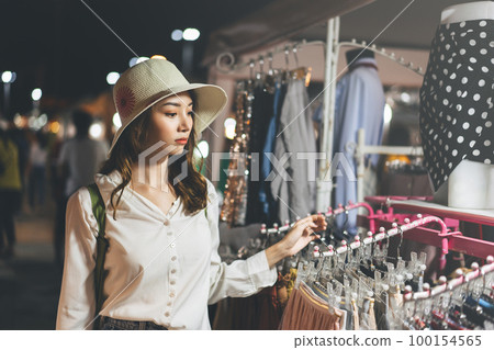 Young adult southeast asian woman at night market 100154565