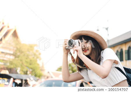 Happy young asian woman backpack local travel and take a photo with camera. Happy young asian woman backpack local travel and take a photo with camera. 100154707