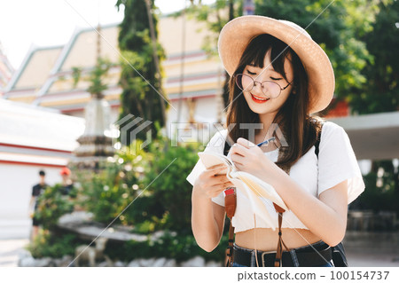 Young asian cute glasses teenager girl traveller backpack solo local travel with memo written daily. Young asian cute glasses teenager girl traveller backpack solo local travel with memo written daily. 100154737