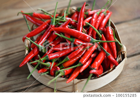 Chili pepper, Red hot chilli peppers on basket background. Close up group of ripe red chilli 100155285