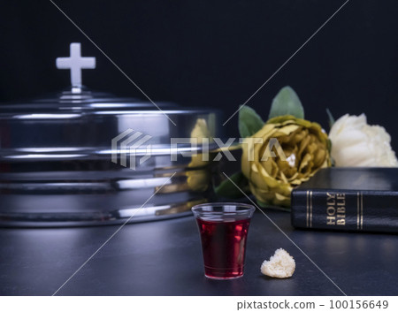 Taking communion the wine and the bread symbols on black background 100156649