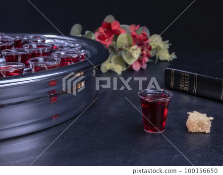 Taking communion the wine and the bread symbols on black background 100156650
