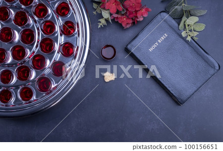 Taking communion the wine and the bread symbols on black background 100156651