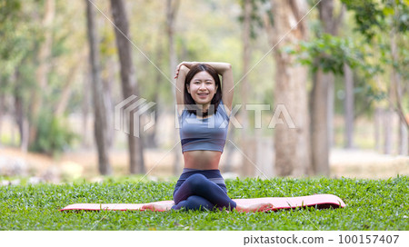 Asian woman doing yoga in nature in the forest, Meditation and breathing exercises, Treat ADHD and train your mind to be calm, Healthy exercise, Mindfulness, Homeopathy, Park yoga. Asian woman doing yoga in nature in the forest, Meditation and breathing exercises, Treat ADHD and train your mind to be calm, Healthy exercise, Mindfulness, Homeopathy, Park yoga. 100157407