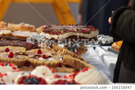 Selling desserts and delicacies at the confectionery stand at the farmers street food market Selling desserts and delicacies at the confectionery stand at the farmers street food market 100158047