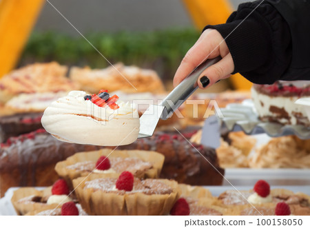 Selling desserts and delicacies at the confectionery stand at the farmers street food market 100158050