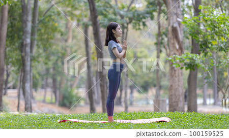 Asian woman doing yoga in nature in the forest, Meditation and breathing exercises, Treat ADHD and train your mind to be calm, Healthy exercise, Mindfulness, Homeopathy, Park yoga. 100159525