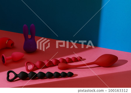 Different adult sex toys such as dildo, vibrator, buttplug on colored background. Sex shop concept 100163312