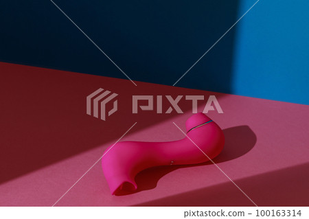Sex toy for women also called vacuum clitoral stimulator for satisfaction on pink background  100163314