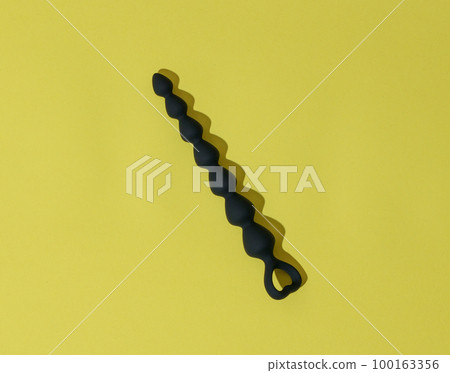 Anal Dildo All The W - Anal plug or dildo on yellow background with... - Stock Photo [100163356] -  PIXTA