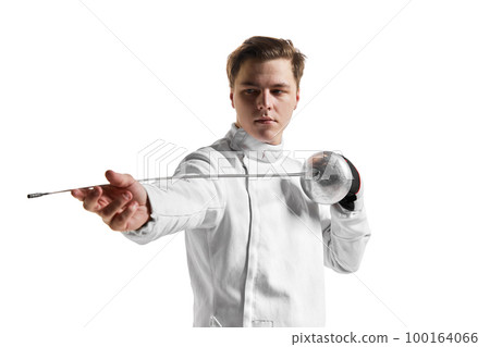 Young man, male fencer in fencing costume mask standing with sword over white studio background. Sport, motivation, professional skills 100164066