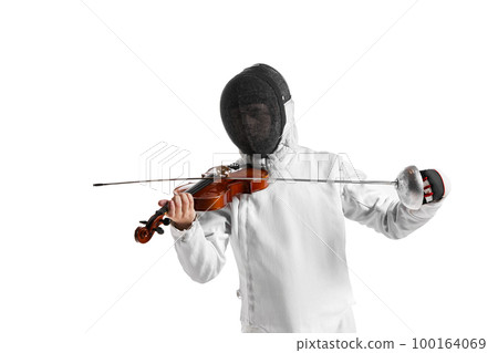 Young man, male fencer in fencing costume and protective mask helmet playing violin over white background. Concept of sport, music, hobbies 100164069