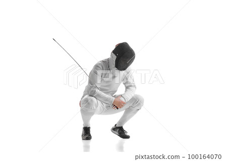 Full-length portrait of sportive man, professional fencer in fencing costume and protective helmet mask have rest isolated on white studio background. Full-length portrait of sportive man, professional fencer in fencing costume and protective helmet mask have rest isolated on white studio background. 100164070