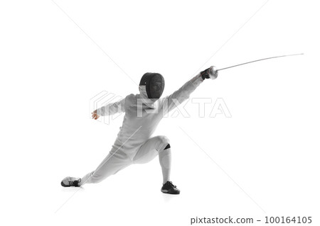 Dynamic portrait of male athlete in fencing costume with sword in hand in action isolated on white studio background. Dynamic portrait of male athlete in fencing costume with sword in hand in action isolated on white studio background. 100164105
