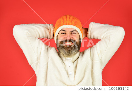 Warm smiles. bearded man wear winter hat. fashion clothes for cold weather. mature hipster red background. male fashion style. autumn weather forecast. knitwear hat protect from cold Warm smiles. bearded man wear winter hat. fashion clothes for cold weather. mature hipster red background. male fashion style. autumn weather forecast. knitwear hat protect from cold 100165142
