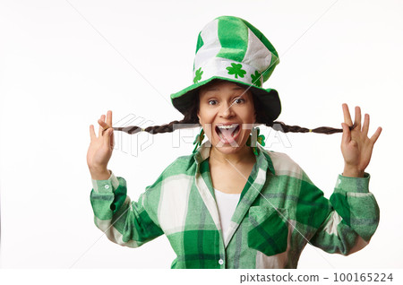 Beautiful amazed woman in green hat with clover leaves, expressing positive emotions, looking at camera, isolated on white background. Saint Patrick's Day. Irish culture and traditional beer festival 100165224