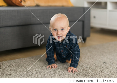 Nursery baby boy crawling on floor indoors at home copy space and empty space for text - Baby curiosity and child development stages Nursery baby boy crawling on floor indoors at home copy space and empty space for text - Baby curiosity and child development stages 100165809