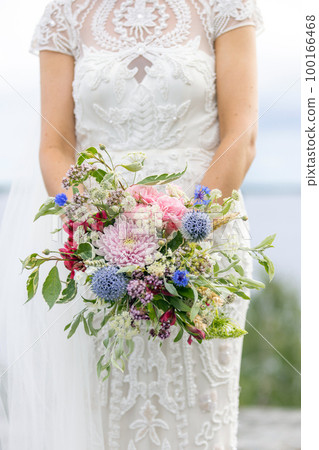 beautiful bride holding bunch of flowers in hand beautiful bride holding bunch of flowers in hand 100166468
