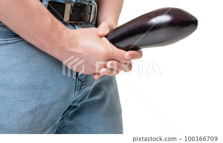 Man crop view holding eggplant at crotch level Stock Photo