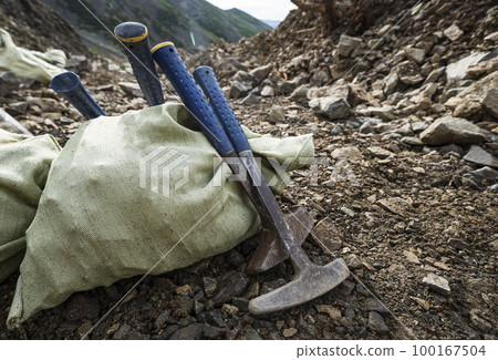 Soil Test. Agronomist putting soil with garden shovel in soil sample bag outdoor. Environmental research 100167504