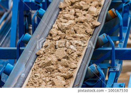 Industrial belt conveyor moving raw materials from mine Industrial belt conveyor moving raw materials from mine 100167530