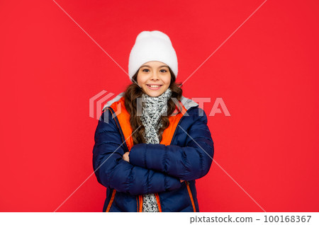 teen girl on red background. portrait of child wearing warm clothes with scarf. teen girl on red background. portrait of child wearing warm clothes with scarf. 100168367
