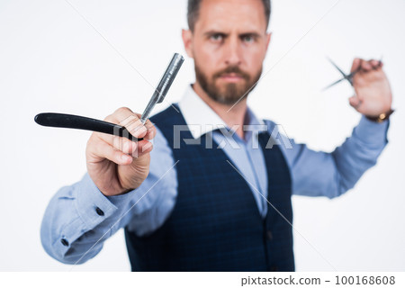 retro razor blade in hand of professional hairdresser, selective focus, hairdressing retro razor blade in hand of professional hairdresser, selective focus, hairdressing 100168608