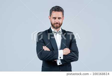 stylish and confident look of event manager. mature unshaven man with bristle. handsome businessman in tuxedo. male fashion bow tie. aesthetic development. luxury and success stylish and confident look of event manager. mature unshaven man with bristle. handsome businessman in tuxedo. male fashion bow tie. aesthetic development. luxury and success 100168614