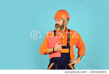 Buy materials for renovation. Bearded storekeeper. Checklist. Inspecting. Control concept. Foreman with document. Delivering building materials. Man in hard hat holding clipboard looking information Buy materials for renovation. Bearded storekeeper. Checklist. Inspecting. Control concept. Foreman with document. Delivering building materials. Man in hard hat holding clipboard looking information 100168683