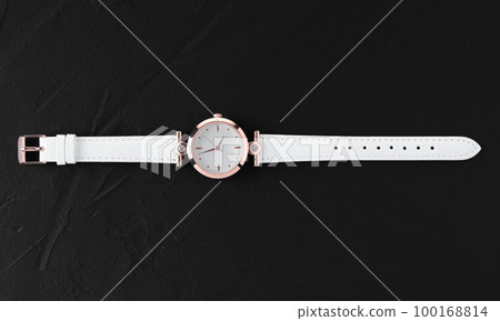 Luxury white female wristwatch on black background 100168814