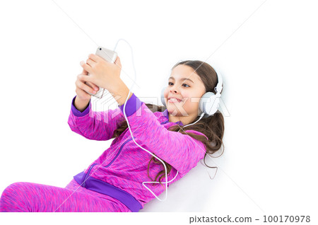 photo of smiling teen girl making selfie on phone. teen girl making selfie on phone isolated on white 100170978