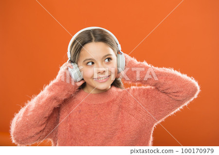 DJ, put the record on. Cute small child wearing DJ headphones. Little girl listening to music and dancing on silent disco in earphones. Adorable DJ girl. Enjoying music playing on DJ party 100170979