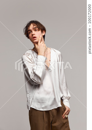 Fashion portrait of stylish high fashionable boy posing isolated over grey background. Concept of modern fashion, uniqueness, ad Fashion portrait of stylish high fashionable boy posing isolated over grey background. Concept of modern fashion, uniqueness, ad 100172000