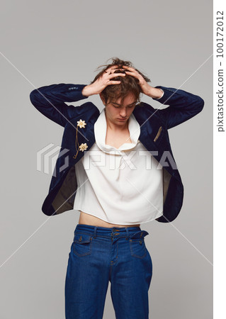Fashion portrait of stylish high fashionable boy posing isolated over grey background. Concept of modern fashion, uniqueness, ad Fashion portrait of stylish high fashionable boy posing isolated over grey background. Concept of modern fashion, uniqueness, ad 100172012