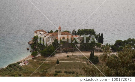 Bol on Brac island. Monastery on pebble beach in Bol view, island of Brac, archipelago of Dalmatia, Croatia Bol on Brac island. Monastery on pebble beach in Bol view, island of Brac, archipelago of Dalmatia, Croatia 100172075