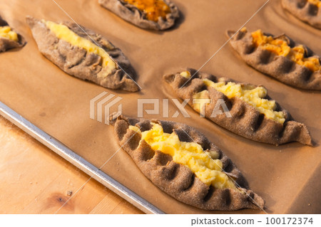 Homemade Karelian pasties with mashed potato and carrot, close up Homemade Karelian pasties with mashed potato and carrot, close up 100172374
