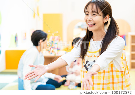 Nursery teacher working at a nursery school Nursery teacher working at a nursery school 100172572