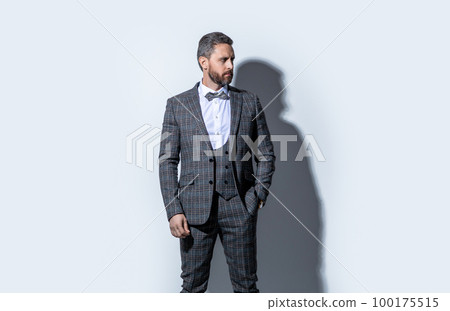 photo of handsome guy wearing tuxedo. guy wear tuxedo formal suit. guy in tuxedo on grey 100175515