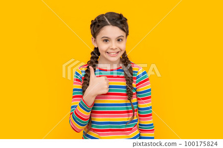 photo of teen girl show thumb up. childhood studio shot of teen girl. concept of childhood. 100175824