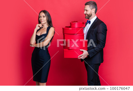 positive valentine couple in love at studio. valentine couple in love on background. positive valentine couple in love at studio. valentine couple in love on background. 100176047