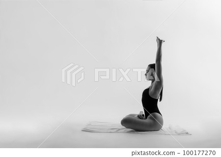 Athletic woman in swimsuit, doing yoga, push-ups, beautiful female exercising at studio 100177270