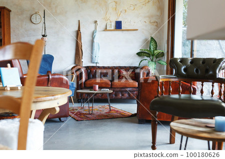 Scandinavian interior style, armchair in front, natural light from window.Zero waste home concept.Wooden furniture Scandinavian interior style, armchair in front, natural light from window.Zero waste home concept.Wooden furniture 100180626