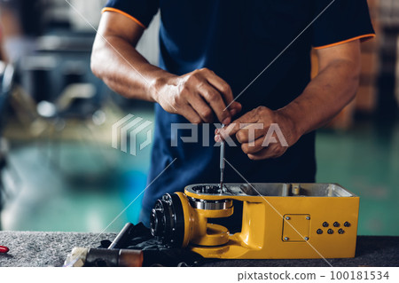 Engineer or technician assemble parts of new robot arms in the factory for modernization of production.  100181534