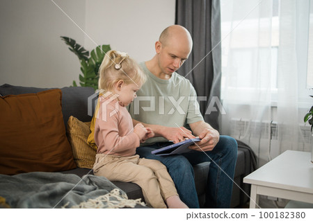 Deaf child girl with cochlear implant studying to hear sounds and have fun with father - recovery after cochlear Implant surgery and rehabilitation concept Deaf child girl with cochlear implant studying to hear sounds and have fun with father - recovery after cochlear Implant surgery and rehabilitation concept 100182380